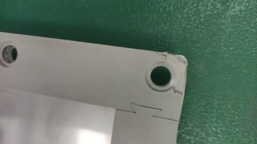 Close-up of ESS unit metal bracket showing manufacturing detail during quality inspection in China