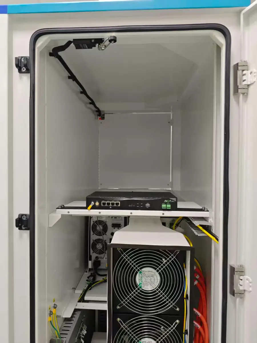 Interior view of energy storage system cabinet showing EMU, cooling fans, and wiring at Chinese manufacturing facility